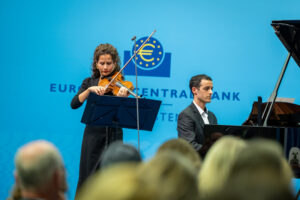 International Holocaust Remembrance Day, Frankfurt am Main, 27 January 2026.  To mark International Holocaust Remembrance Day, the ECB held a ceremony on Tuesday, 27 January 2026. Each year, the European Central Bank honours the victims of the Holocaust, including those who were deported from Frankfurt’s Grossmarkthalle. This year’s commemorative event included a conversation between ECB President Christine Lagarde and designer and philanthropist Diane von Fürstenberg, whose parents survived the Holocaust. Mrs von Fürstenberg spoke about her family’s story and offered reflections on intergenerational trauma and resilience and received a magnolia tree with the name of her mother Lilliane Nahmias. The ceremony also featured   speeches by: * Christine Lagarde, ECB President * Ina Hartwig, Frankfurt City Councilor for Culture and Science * Mirjam Wenzel, Director of the Jewish Museum Frankfurt * Uwe Becker, Hessian State Commissioner for Jewish Life and the Fight against Antisemitism music performances by Tal Strauss, Hagit Half and Anne-Sophie Bertrand a jewish prayer by Rabbi Soussan and Cantor Guenon and a symbolic laying of stones by Diane von Fuerstenberg, Christine Lagarde, Philippe Halfin, Luis de Guindos, Philip Lane, Isabel Schnabel, Piero Cipollone, Marc Gruenbaum and other guests. Description International Holocaust Remembrance Day, Frankfurt am Main, 27 January 2026.  To mark International Holocaust Remembrance Day, the ECB held a ceremony on Tuesday, 27 January 2026. Each year, the European Central Bank honours the victims of the Holocaust, including those who were deported from Frankfurt’s Grossmarkthalle. This year’s commemorative event included a conversation between ECB President Christine Lagarde and designer and philanthropist Diane von Fürstenberg, whose parents survived the Holocaust. Mrs von Fürstenberg spoke about her family’s story and offered reflections on intergenerational trauma and resilience and received a magnolia tree with the name of her mother Lilliane Nahmias. The ceremony also featured   speeches by: * Christine Lagarde, ECB President* Ina Hartwig, Frankfurt City Councilor for Culture and Science* Mirjam Wenzel, Director of the Jewish Museum Frankfurt* Uwe Becker, Hessian State Commissioner for Jewish Life and the Fight against Antisemitismmusic performances by Tal Strauss, Hagit Halaf and Anne-Sophie Bertrand.
